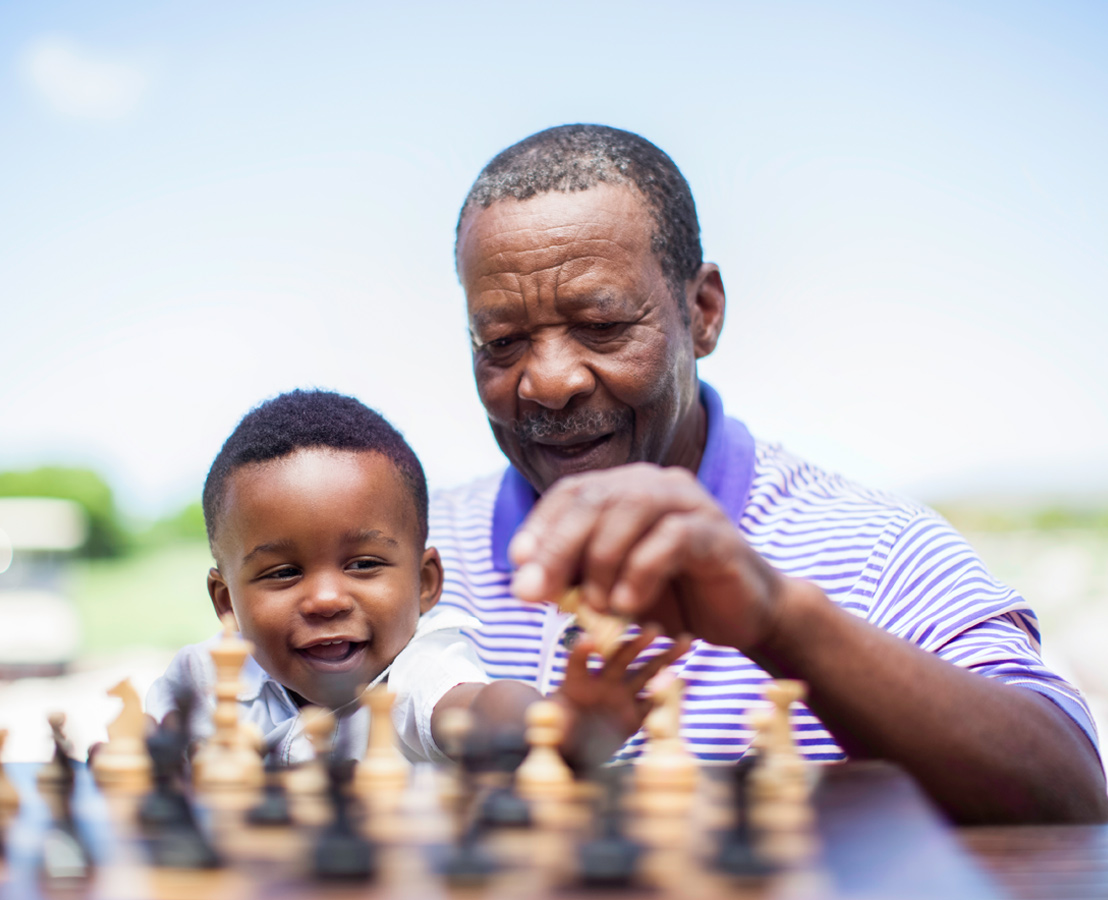 Man and child playing chess
