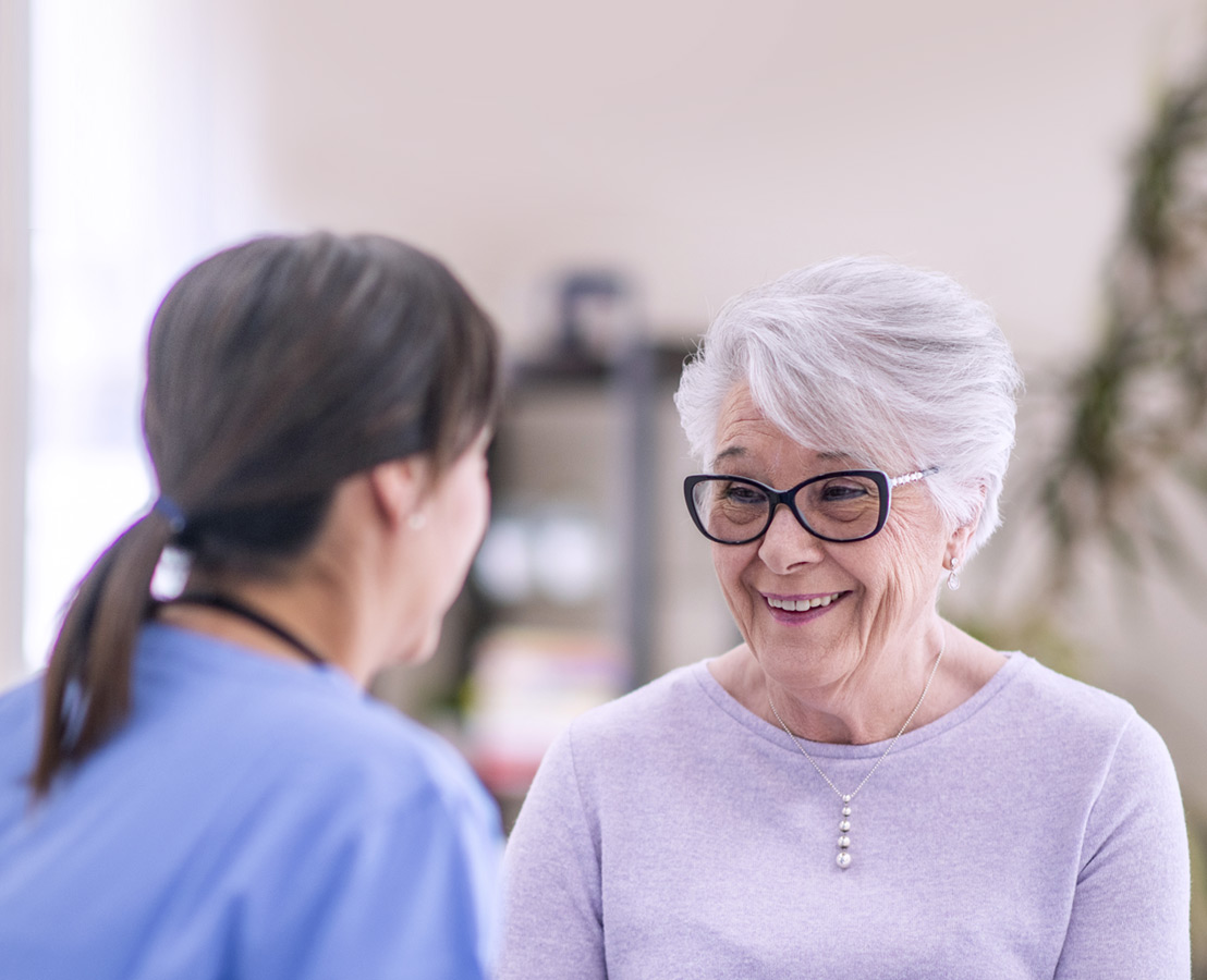 Nurse speaking with old woman