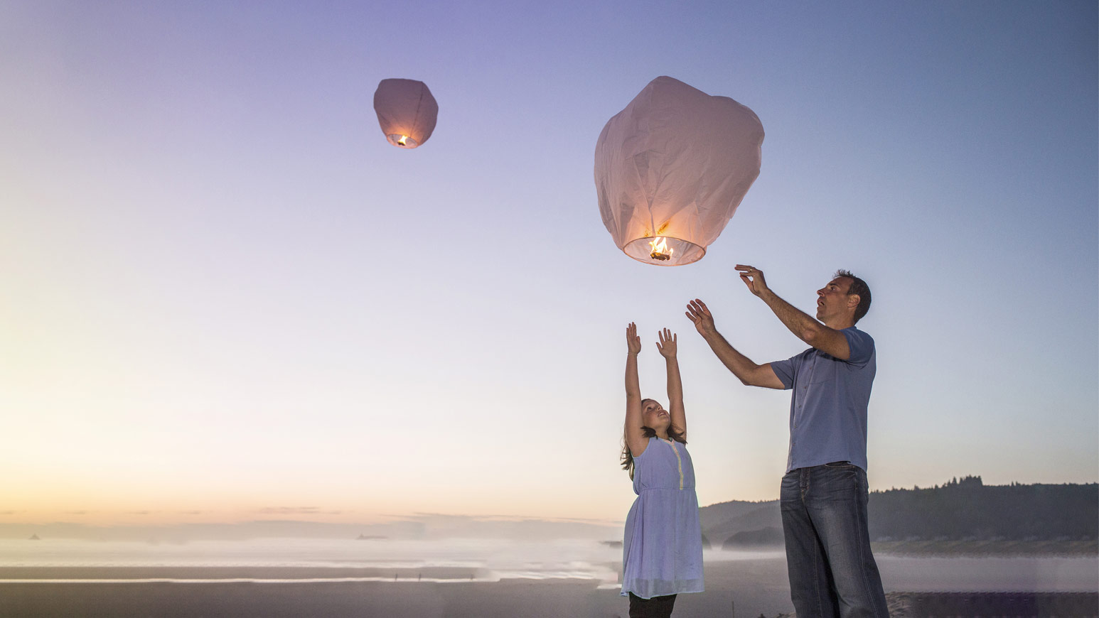Father And Daughter Releasing Lantern